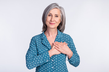 Photo of happy smiling peaceful beautiful businesswoman hold hands chest thankful isolated on grey...