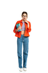 Fototapeta premium full length of surprised young student in glasses holding books isolated on white