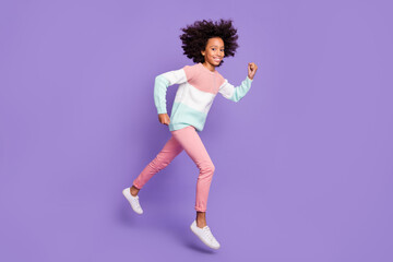 Full size profile side photo of young beautiful smiling afro girl running in air isolated on purple color background