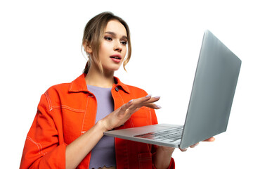 young woman in orange shirt using laptop isolated on white