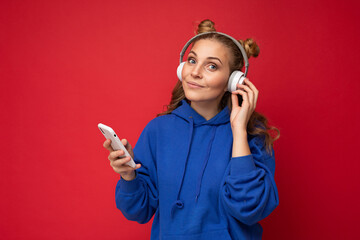 Photo shot of beautiful joyful smiling young female person wearing stylish casual outfit isolated...