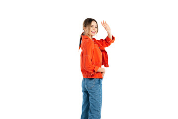 Fototapeta premium happy young woman in jeans and orange shirt waving hand isolated on white