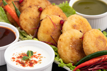 Aloo Tikki Also Known As Alu Ki Tikkia Is Seasoned Boiled Mashed Potato Cutlet Or Patties Used In Various Indian Street Food Masala Chaat Snacks. Served With Dahi Chat Powder Anar And Sev Bhujia