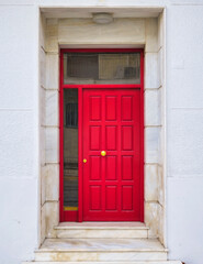 Fototapeta na wymiar contemporary house front entrance, red painted door and marble frame