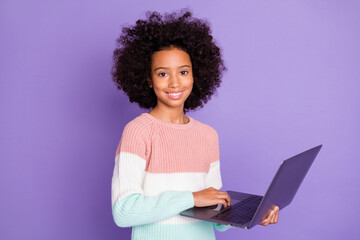 Obraz na płótnie Canvas Portrait of optimistic wavy hairdo girl type laptop wear white sweater isolated on violet background