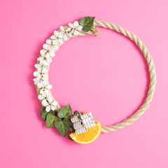 Circular frame from rope with boat and flowers.Flat Lay.Minimal concept.