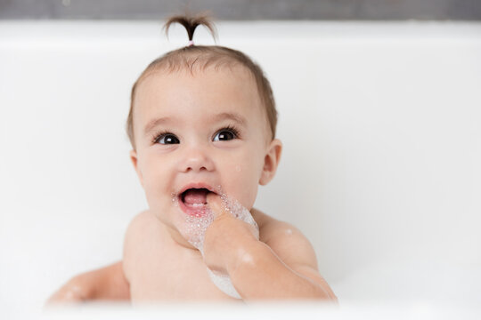 Portrait of happy baby girl in bubble bath