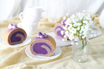 Swiss Roll Cake with sweet purple potato filling set on cafe table.