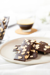 crunchy brittle brownie crisps crackers set on white cafe table.