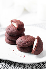 crunchy red velvet cookies set on white cafe table.
