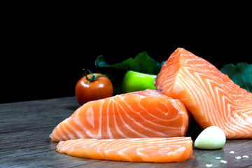Fresh salmon with spices  on the table, garlic, tomato and lemon