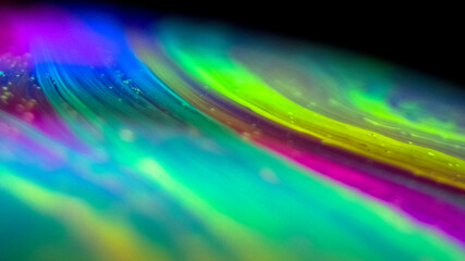 Blurred swish of rainbow colours from macro soap bubble