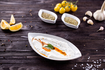 Assorted Middle Eastern and arabic dishes on a dark rustic background. Hummus, tabbouleh, pita, meat kebab, falafel, baklava. Halal food. Top view. Turkish foods, Turkish pizza, Turkish breakfast