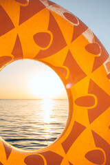 Inflatable pineapple floating in sea. Close up shot of rubber ring with space for text. Summer concept. Top view, copy space.