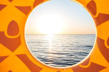 Inflatable pineapple floating in sea. Close up shot of rubber ring with space for text. Summer concept. Top view, copy space.