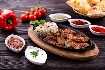 Assorted Middle Eastern and arabic dishes on a dark rustic background. Hummus, tabbouleh, pita, meat kebab, falafel, baklava. Halal food. Top view. Turkish foods, Turkish pizza, Turkish breakfast
