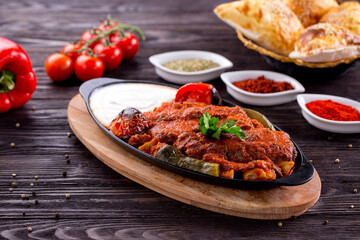Assorted Middle Eastern and arabic dishes on a dark rustic background. Hummus, tabbouleh, pita, meat kebab, falafel, baklava. Halal food. Top view. Turkish foods, Turkish pizza, Turkish breakfast