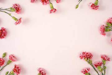 Design concept of Mother's day holiday greeting with carnation bouquet on pink table background