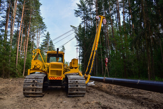 Natural Gas Pipeline Construction. Gas and Crude oil transmission in pipe from gas storage and plant development to facility.  Excavator and pipelayer during building of transit petrochemical pipes