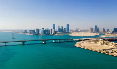 Deurstickers Aerial view of Abu Dhabi skyline rising over the seaside forming modern waterfront of the UAE capital © creativefamily