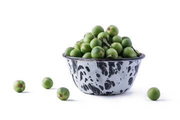 turkey berry, also called wild eggplant or pea eggplant, cup full of round vegetable isolated on white background