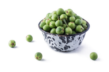 turkey berry, also called wild eggplant or pea eggplant, cup full of round vegetable isolated on white background