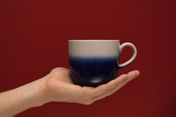 hand holding a cup