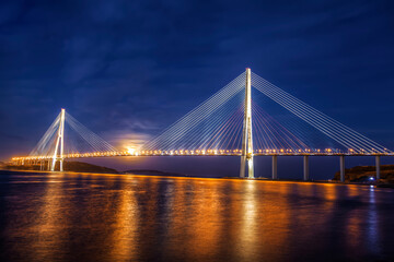 The bridge Russian over the Bosphorus East Strait in night illumination. Vladivostok, Russia
