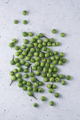 turkey berry, also called wild eggplant or pea eggplant, round vegetable on a textured white background
