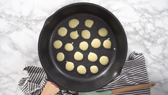 Flat lay. Step by step. Frying mini pancake cereal in a nonstick frying pan.