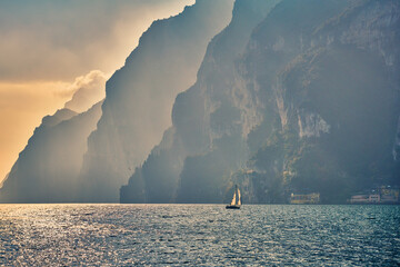 View of the beautiful Lake Garda surrounded by mountains, Scenic view of sunset at Lake Garda in...