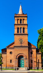 Fototapeta na wymiar Church of Holy Virgin Mary Queen of Poland at Chrobrego street in old town historic city center of Gniezno in Grater Poland region