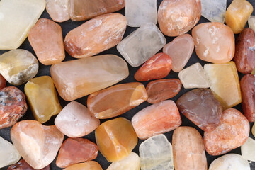 Red silk jade heap jewel stones texture background. Place for text.