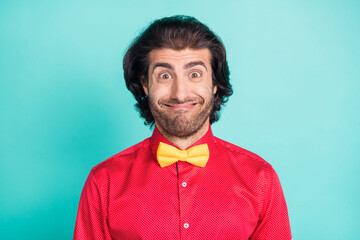 Photo of funny silly young happy man make funky face fooling wear yellow bowtie isolated on teal color background