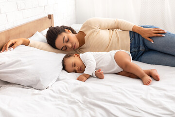 African Mother And Her Baby Son Sleeping In Bed Indoor