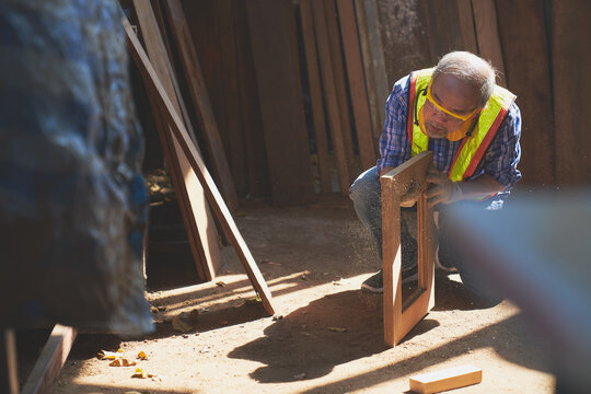 Old Man Carpenter Check Quality Of Wood Frame To Clear Dust On Lighting , Woodworker Industrial