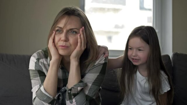 Tired woman cannot respond to the outcry of a child. The child wants to get the mother's attention.
