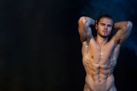 Sexy sport muscle fit strongface guy stripped on black isolated font background with smoke