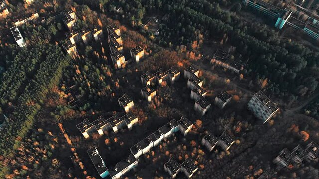 View of ghost city of Pripyat with Chernobyl nuclear power plant and sarcophagus on background. 35 years after disaster and evacuation. Traveling during pandemic of Covid-19