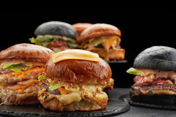 Many different burgers on dark