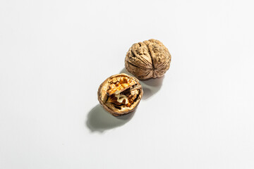 Whole and half walnuts isolated on white background