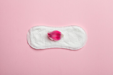 Menstruation, woman intimate hygiene, woman's health, sanitary pad on pink and flower petal © zakalinka