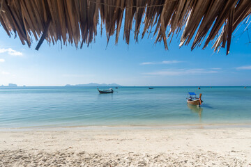 Beautiful tropical beach with white sand and palapa (thatched roof)