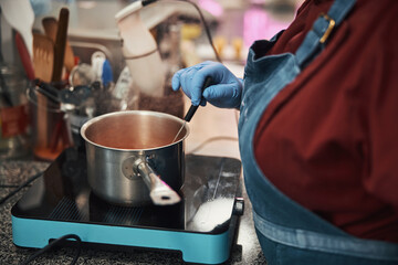 Busy chef in gloves preparing ingredients for the meal