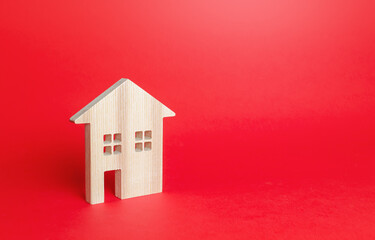 Obraz na płótnie Canvas Wooden figurine of a residential building. Minimalism. Affordable housing. Rent of real estate. Construction industry. Realtor services. Utility services. Repair and renovation, modernization.