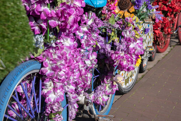 Fototapeta na wymiar Bicycles With Flower Decorations At Amsterdam The Netherlands 25-3-2020