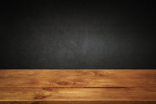 The background is blank wooden boards and a textured plastered wall with lighting and vignetting.