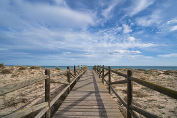 Obraz premium Wooden beach path headed toward the sea in the city of Valencia, in Spain.