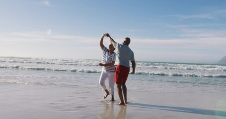 Senior african american couple dancing at the beach