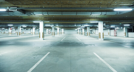 Horizontal image of clean white underground parking lot